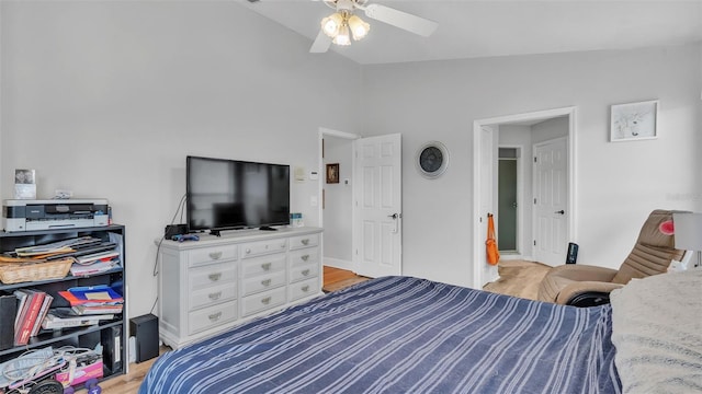 bedroom featuring ceiling fan, light hardwood / wood-style flooring, and vaulted ceiling