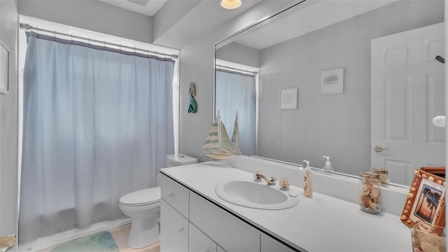 bathroom with vanity, tile patterned flooring, and toilet