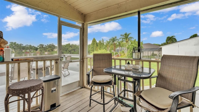 sunroom featuring vaulted ceiling