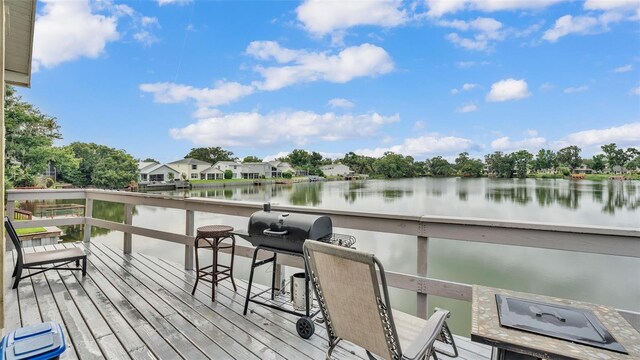 wooden terrace featuring a water view