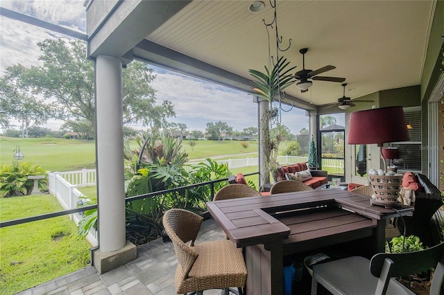 sunroom with ceiling fan