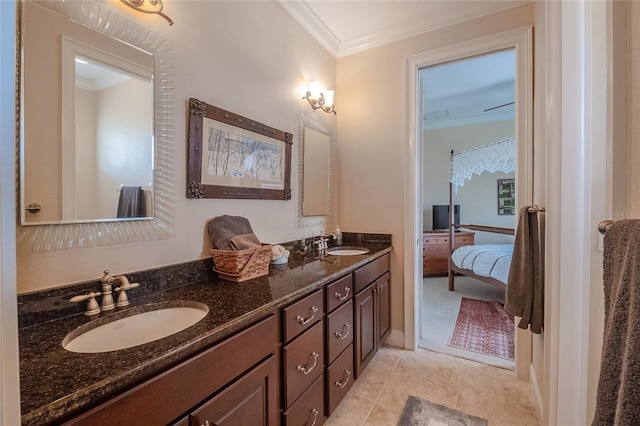 full bathroom featuring crown molding, double vanity, and a sink