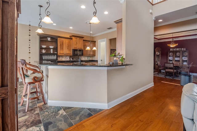 kitchen with ornamental molding, open shelves, a sink, black microwave, and brown cabinetry
