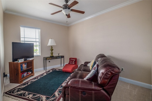 carpeted living area with baseboards, ceiling fan, and crown molding