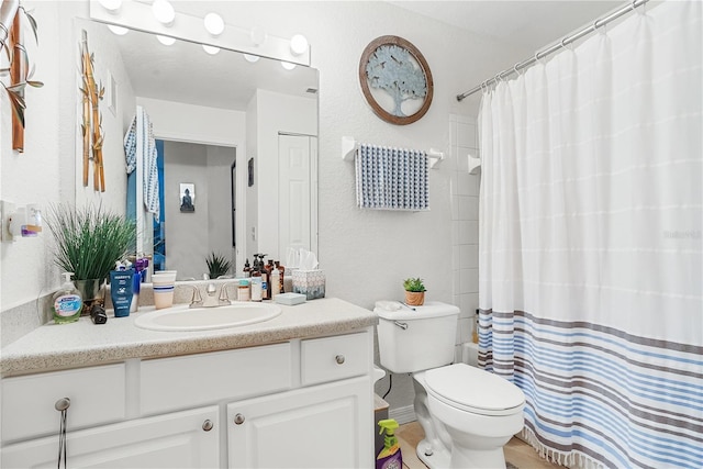 4255 Summer Landing Dr Unit 106, Lakeland, FL 33810 - bathroom with vanity, toilet, a textured wall, and a shower with curtain