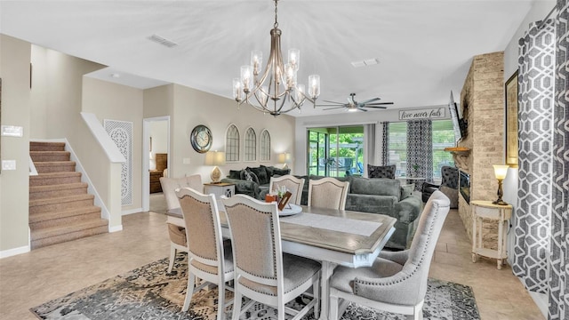 dining area featuring visible vents, stairway, baseboards, and ceiling fan with notable chandelier