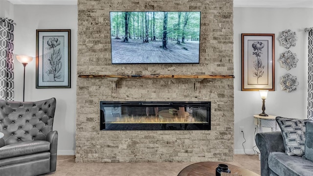 interior space featuring a large fireplace, light tile patterned floors, and baseboards