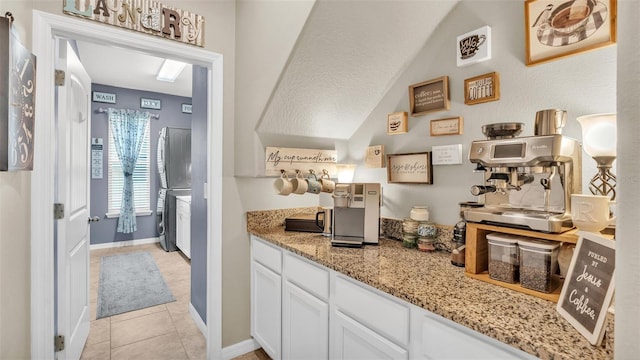 bar featuring light tile patterned flooring and baseboards