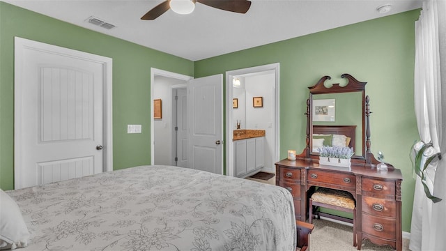 bedroom with a ceiling fan, visible vents, and ensuite bathroom