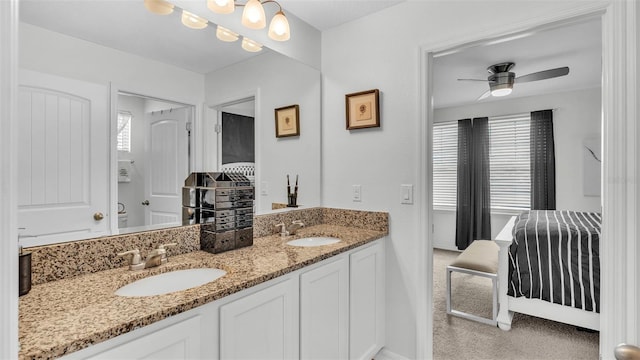 bathroom featuring double vanity, a ceiling fan, and a sink