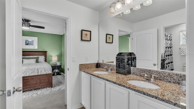 bathroom with a sink, ceiling fan, double vanity, and connected bathroom