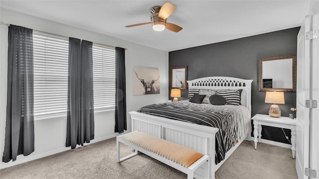 bedroom featuring light carpet, ceiling fan, and baseboards