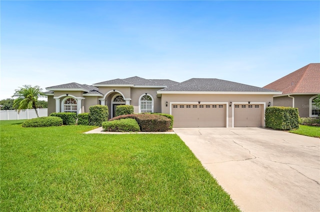 view of front of property featuring a garage and a front lawn