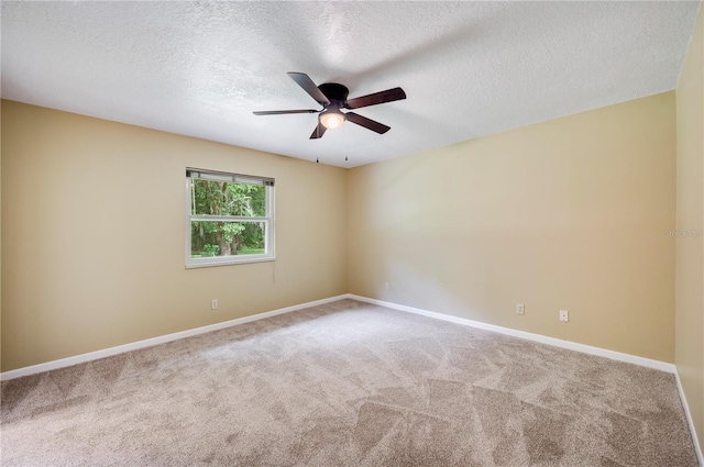 carpeted empty room with ceiling fan and a textured ceiling