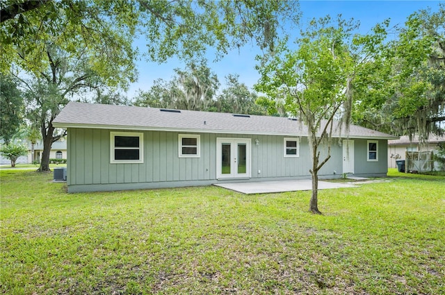 back of property featuring a yard, a patio area, central AC, and french doors