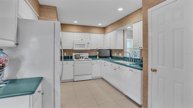 kitchen featuring sink, white cabinets, and white appliances