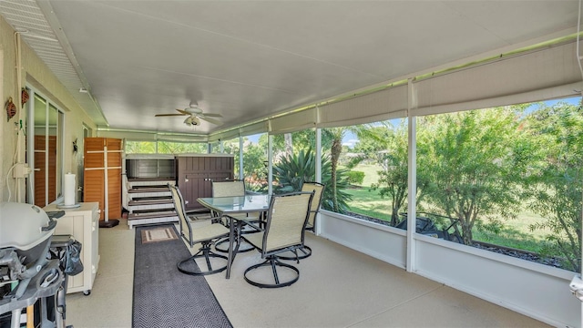 sunroom featuring ceiling fan