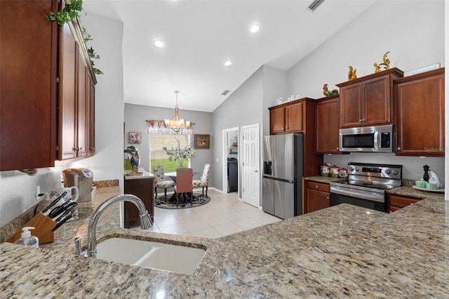 kitchen featuring a notable chandelier, hanging light fixtures, sink, high vaulted ceiling, and stainless steel appliances