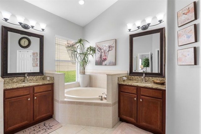 bathroom with tiled bath, tile patterned floors, and vanity