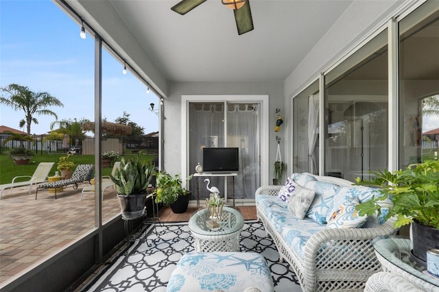 sunroom / solarium featuring ceiling fan