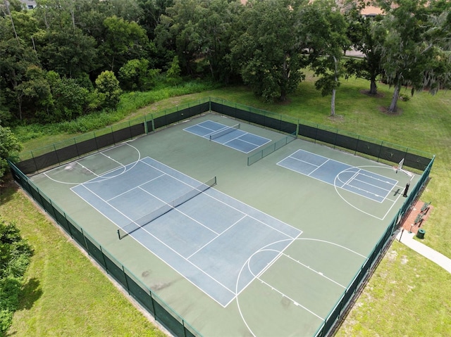 view of sport court featuring a yard