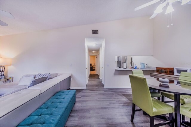 interior space with ceiling fan, sink, hardwood / wood-style flooring, and lofted ceiling