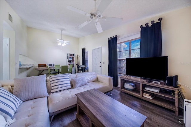 living room featuring ceiling fan and dark hardwood / wood-style flooring