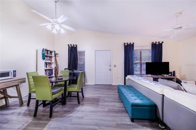 living room featuring lofted ceiling, hardwood / wood-style floors, and ceiling fan