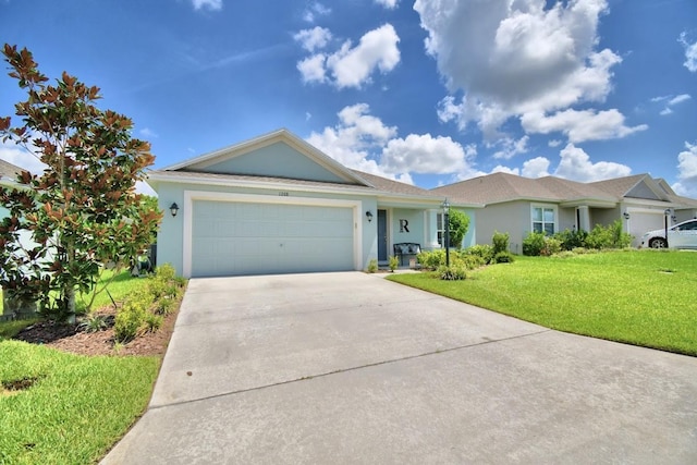 ranch-style home with a garage and a front lawn