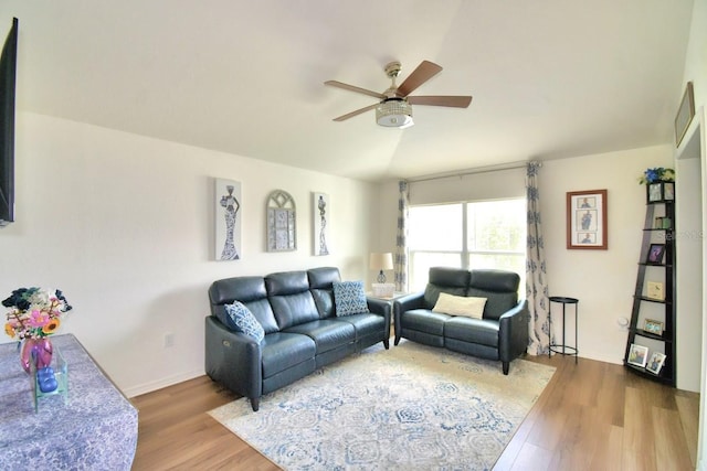 living room featuring vaulted ceiling, hardwood / wood-style floors, and ceiling fan