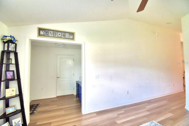 unfurnished room featuring ceiling fan, lofted ceiling, and light hardwood / wood-style floors