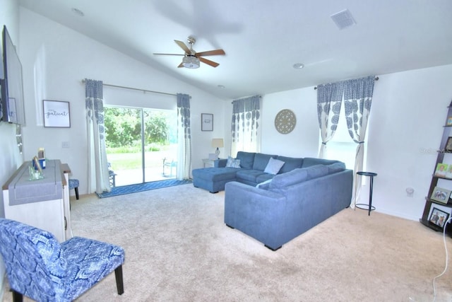 living room with vaulted ceiling, ceiling fan, and carpet