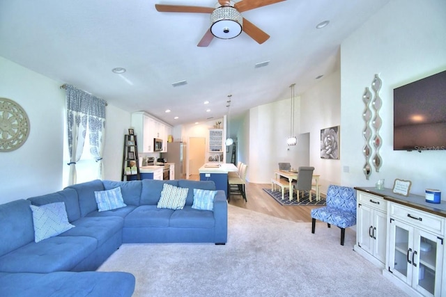 living room with lofted ceiling and ceiling fan