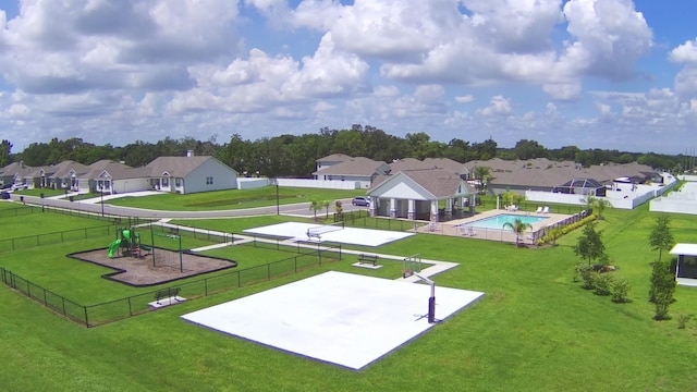 surrounding community with a lawn and volleyball court