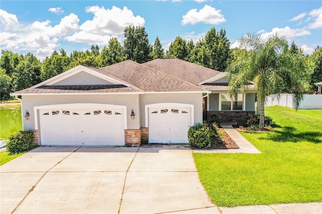 view of front of property featuring a garage and a front lawn