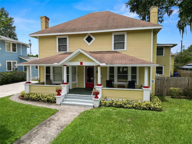 view of front of home featuring a front lawn and covered porch