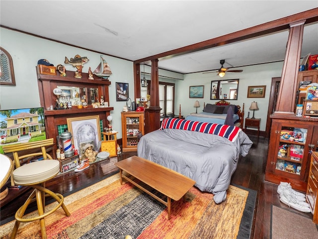 bedroom with beamed ceiling, ceiling fan, and dark hardwood / wood-style floors
