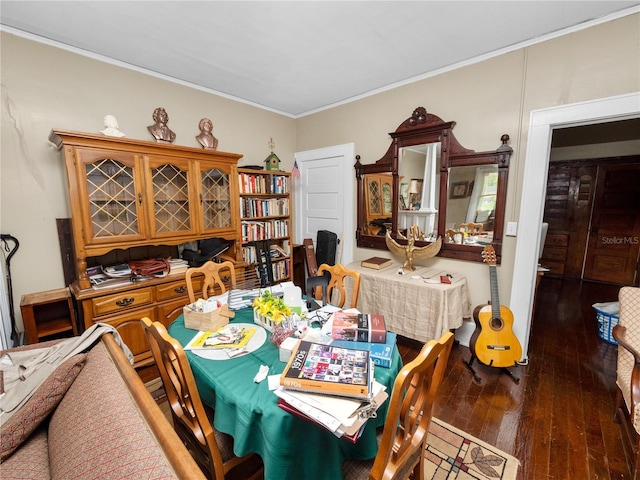 dining area with ornamental molding and dark hardwood / wood-style floors