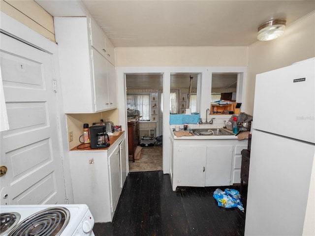 kitchen featuring white refrigerator, sink, white cabinets, and dark hardwood / wood-style flooring