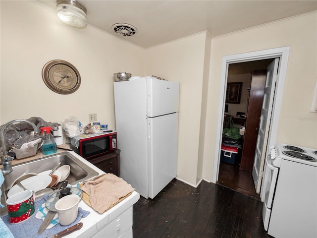 kitchen featuring white cabinetry, dark wood-type flooring, sink, and white appliances