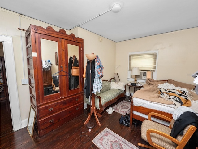 bedroom featuring cooling unit and dark hardwood / wood-style floors