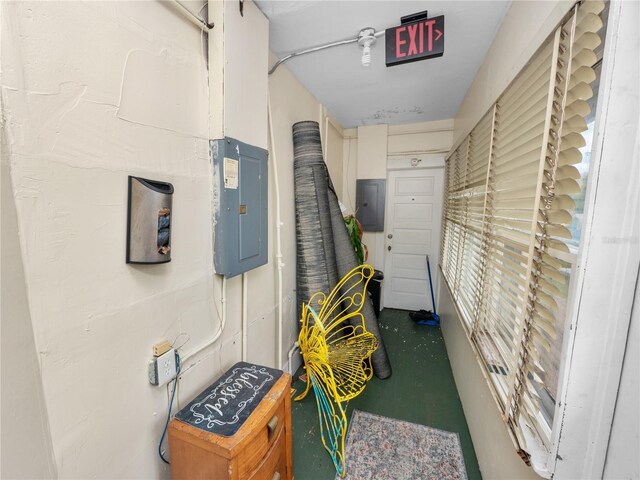 hall featuring concrete flooring and electric panel