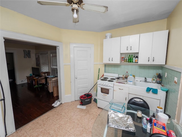kitchen featuring sink, white cabinets, ceiling fan, and white range with electric cooktop