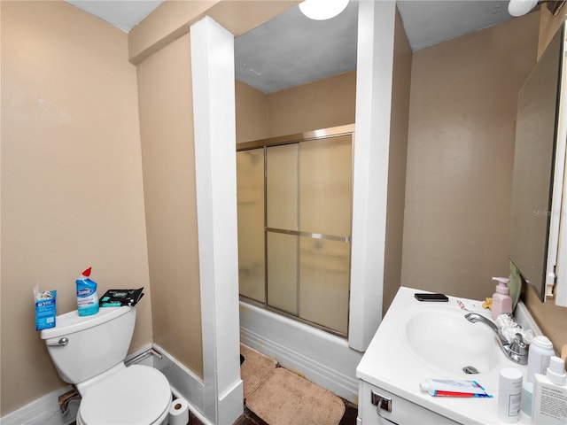 full bathroom featuring vanity, toilet, and combined bath / shower with glass door
