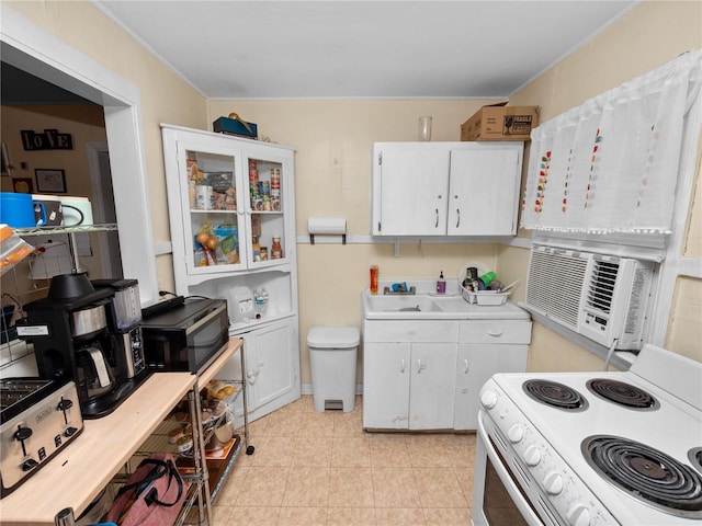 kitchen featuring white cabinetry and electric range