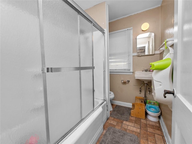 bathroom featuring enclosed tub / shower combo and toilet