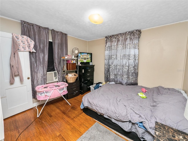 bedroom featuring hardwood / wood-style floors and a textured ceiling