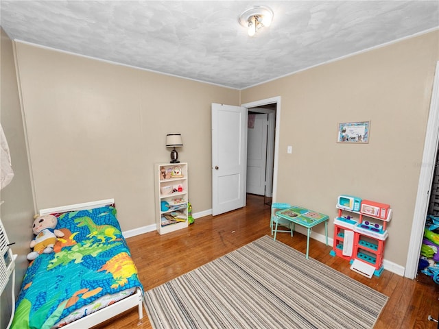 recreation room featuring hardwood / wood-style flooring and a textured ceiling