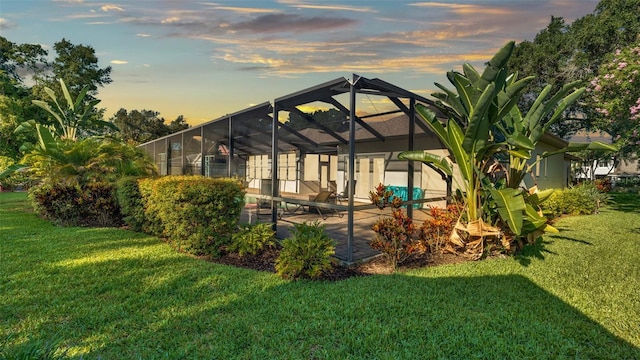 yard at dusk with a patio and a lanai