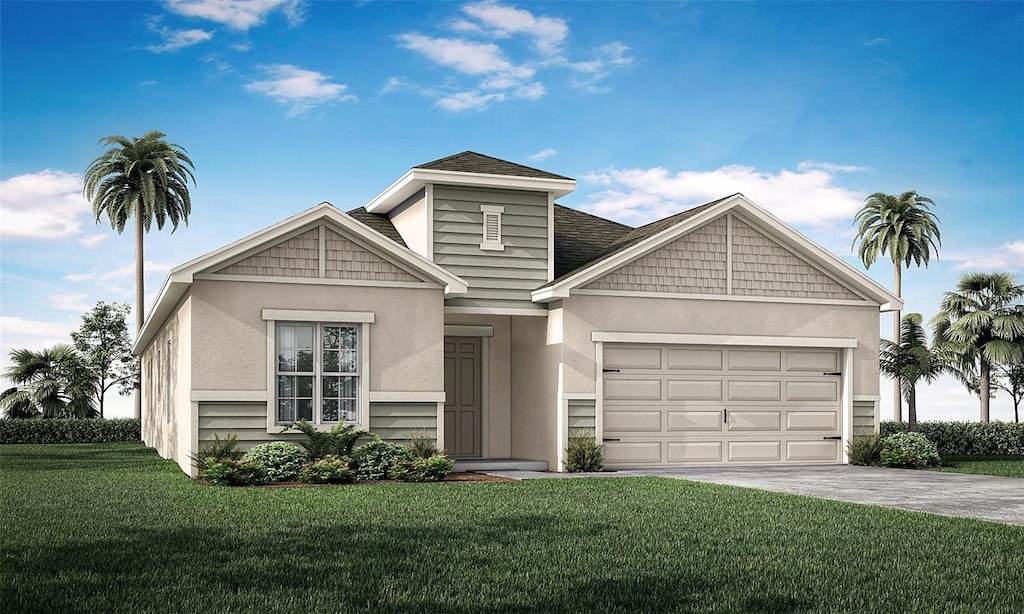 view of front of property with a garage and a front lawn